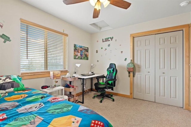 carpeted bedroom with baseboards, a closet, attic access, and a ceiling fan