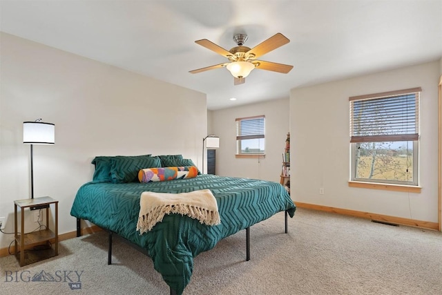 bedroom with carpet flooring, visible vents, baseboards, and ceiling fan