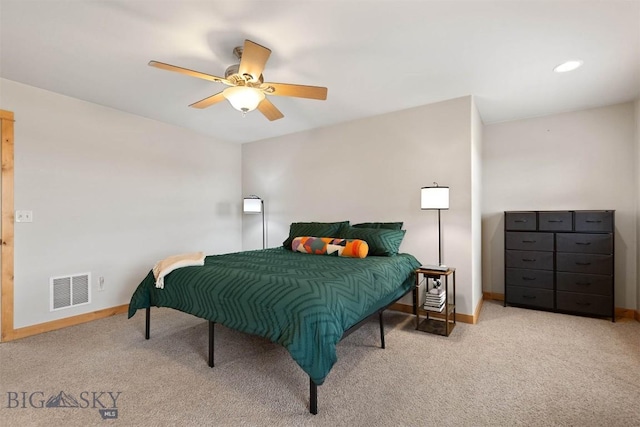 carpeted bedroom with ceiling fan, baseboards, and visible vents