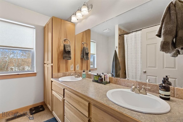 bathroom with tile patterned floors, double vanity, a sink, and visible vents