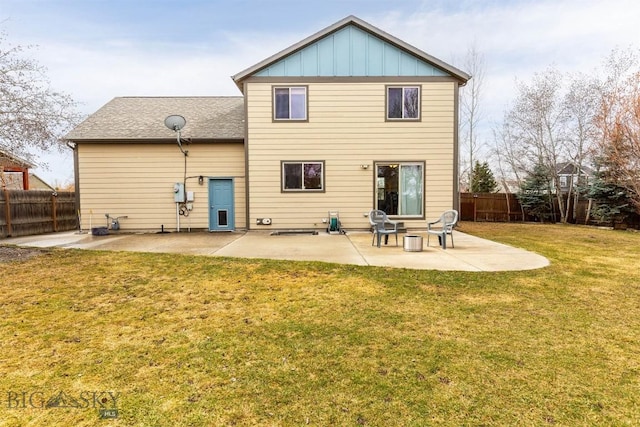 back of property with a patio, a fenced backyard, board and batten siding, and a lawn