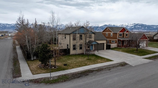 view of front facade featuring a mountain view, a garage, and concrete driveway