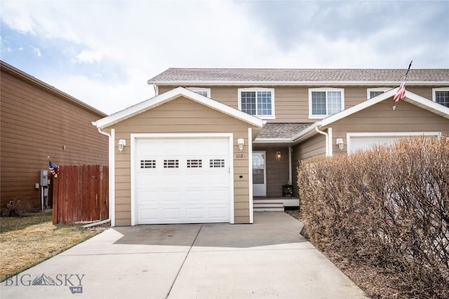 1112 Biehl Unit A, Belgrade, MT 59714 - view of property featuring an attached garage, roof with shingles, driveway, and fence