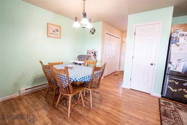 1112 Biehl Unit A, Belgrade, MT 59714 - dining area with light wood-style flooring, baseboards, and baseboard heating
