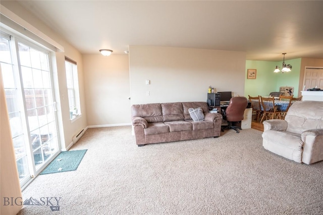 1112 Biehl Unit A, Belgrade, MT 59714 - carpeted living area featuring baseboard heating, a notable chandelier, and baseboards