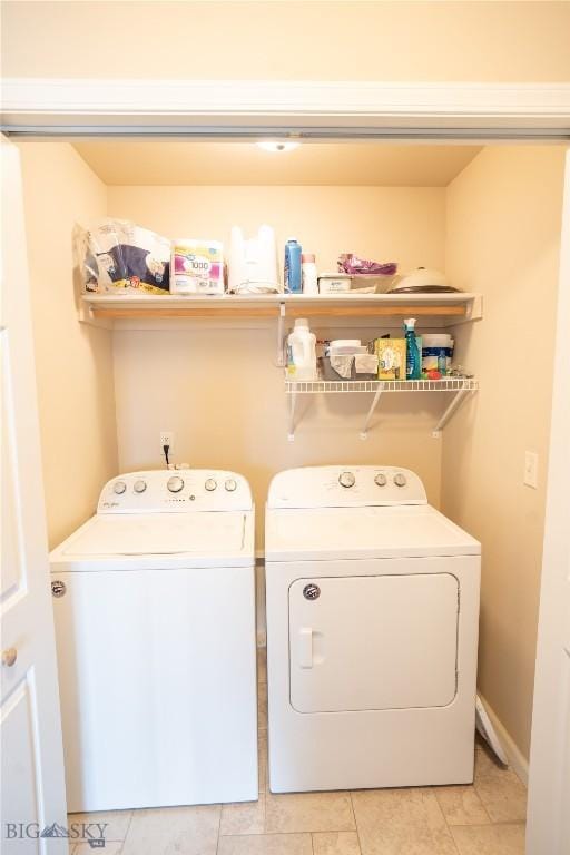 1112 Biehl Unit A, Belgrade, MT 59714 - washroom with light tile patterned flooring, laundry area, and washing machine and clothes dryer