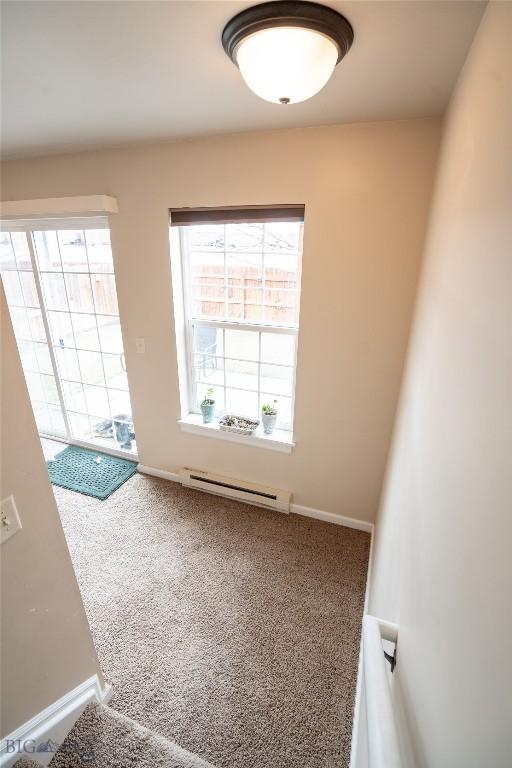 1112 Biehl Unit A, Belgrade, MT 59714 - spare room with a baseboard radiator, baseboards, and carpet floors