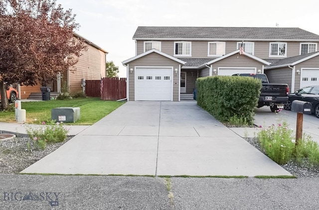 1112 Biehl Unit A, Belgrade, MT 59714 - view of front of home with fence, a shingled roof, and driveway