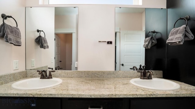 bathroom with double vanity and a sink