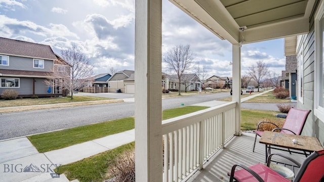 exterior space with a porch and a residential view