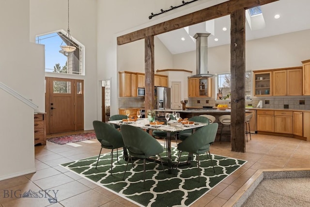 2514 Putter Ct, Bozeman, MT 59715 - dining space with ornate columns, high vaulted ceiling, light tile patterned floors, and recessed lighting