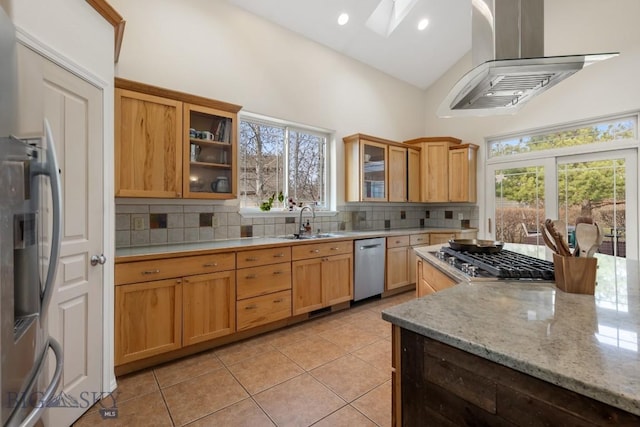 2514 Putter Ct, Bozeman, MT 59715 - kitchen featuring light tile patterned floors, wall chimney range hood, a skylight, a sink, and decorative backsplash