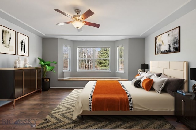 2514 Putter Ct, Bozeman, MT 59715 - bedroom with dark wood-type flooring, baseboards, and a ceiling fan