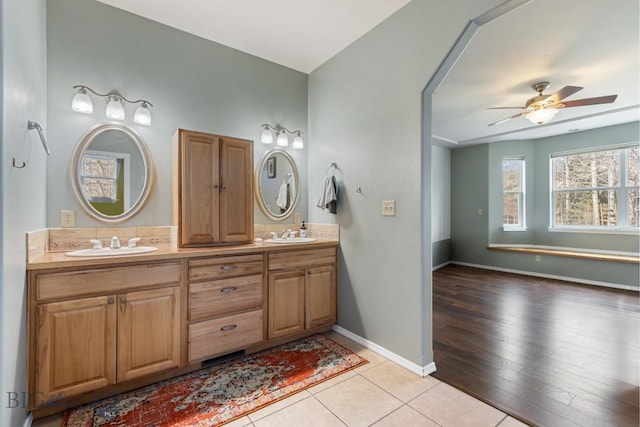 2514 Putter Ct, Bozeman, MT 59715 - full bathroom with double vanity, a sink, a ceiling fan, and baseboards