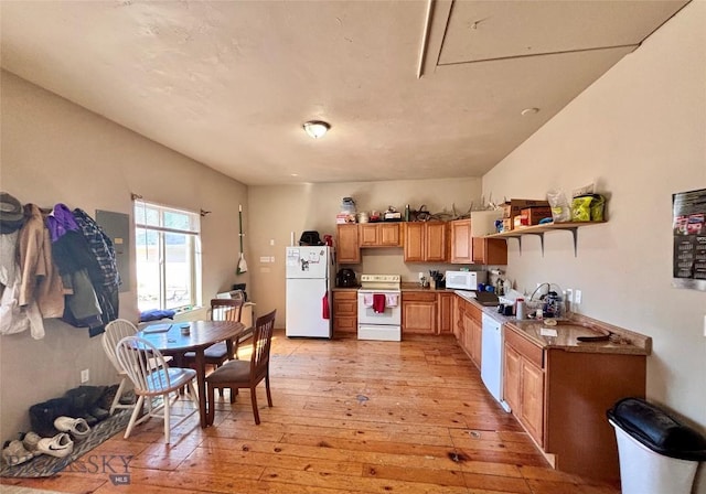 521 E Bannack St, Dillon, MT 59725 - kitchen featuring white appliances, light wood-style floors, a sink, open shelves, and brown cabinets