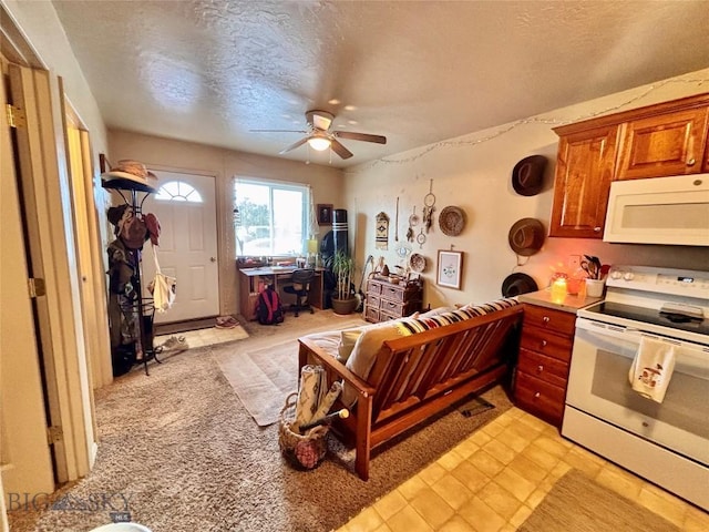 322-328 Vine St, Dillon, MT 59725 - kitchen with brown cabinetry, a textured ceiling, ceiling fan, and white appliances