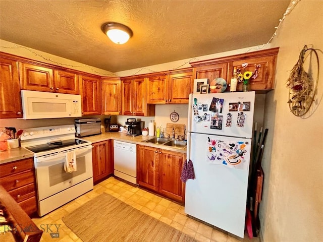 322-328 Vine St, Dillon, MT 59725 - kitchen with a sink, light countertops, white appliances, and a textured ceiling