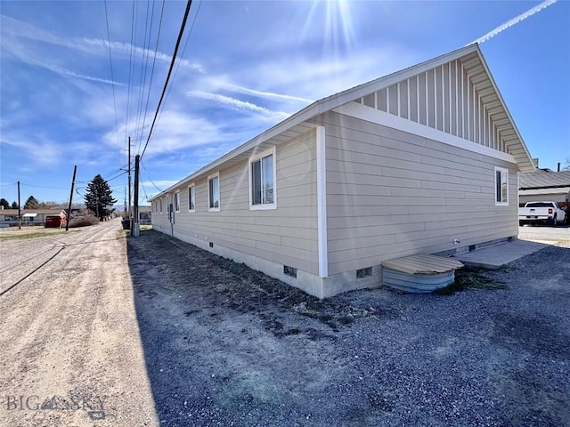 322-328 Vine St, Dillon, MT 59725 - view of side of property featuring crawl space and board and batten siding