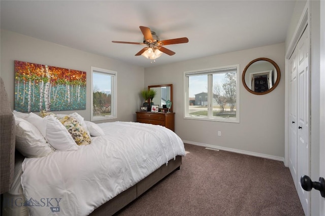 carpeted bedroom with a closet, baseboards, and a ceiling fan