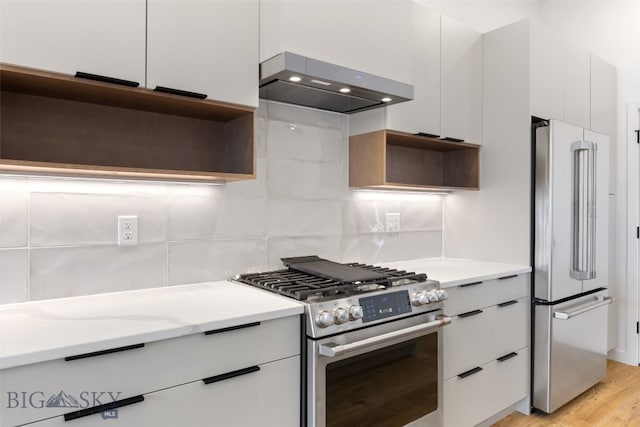 kitchen featuring stainless steel appliances, modern cabinets, open shelves, wall chimney range hood, and white cabinets