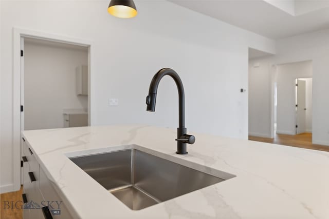 2806 S 30th Ave, Bozeman, MT 59718 - kitchen view of a sink, light wood-style floors, light stone countertops, and white cabinetry