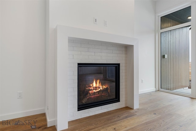2806 S 30th Ave, Bozeman, MT 59718 - detailed view of a brick fireplace, wood finished floors, and baseboards