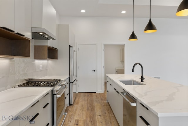 2806 S 30th Ave, Bozeman, MT 59718 - kitchen featuring appliances with stainless steel finishes, a sink, light wood finished floors, modern cabinets, and wall chimney range hood