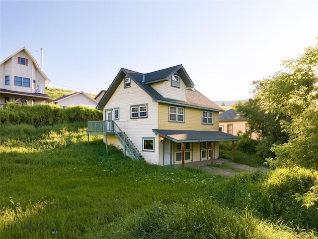 back of property featuring stairway
