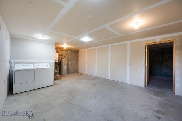 below grade area with water heater and washer and clothes dryer