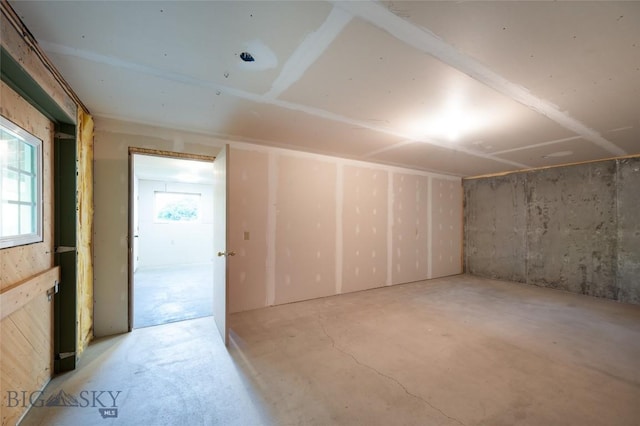additional living space with concrete flooring and a wealth of natural light