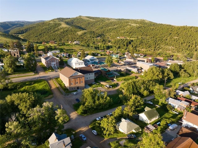 aerial view with a forest view, a mountain view, and a residential view