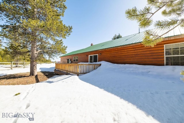 1319 Mcclellan, West Yellowstone, MT 59758 - view of snow covered exterior featuring faux log siding and a deck