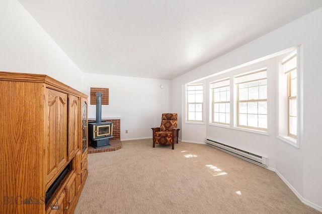 1319 Mcclellan, West Yellowstone, MT 59758 - sitting room featuring baseboard heating, light carpet, and a wood stove
