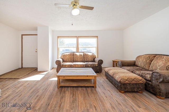 1319 Mcclellan, West Yellowstone, MT 59758 - living room featuring wood finished floors, ceiling fan, and a textured ceiling