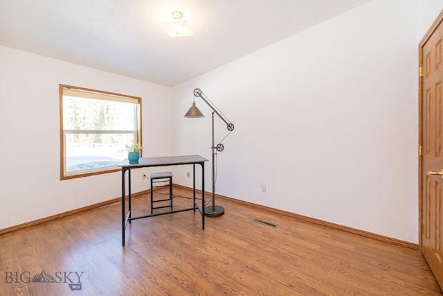 1319 Mcclellan, West Yellowstone, MT 59758 - unfurnished office featuring light wood-style floors and baseboards