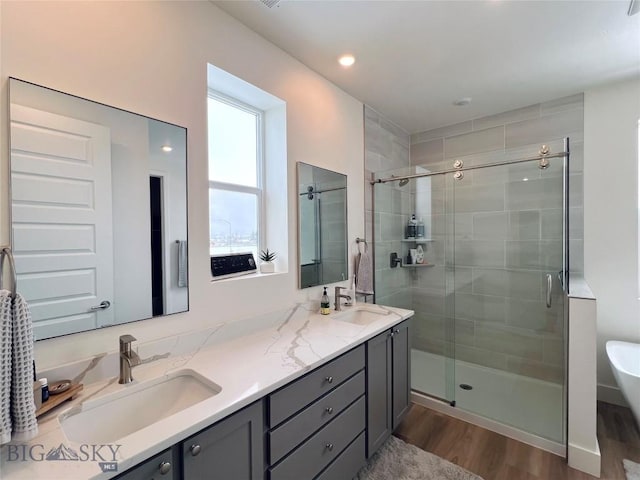 1823 N Cottonwood Rd, Bozeman, MT 59718 - bathroom featuring wood finished floors, a shower stall, and double vanity