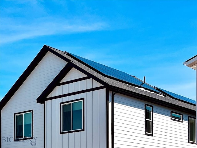 1823 N Cottonwood Rd, Bozeman, MT 59718 - view of property exterior with solar panels, roof with shingles, and board and batten siding