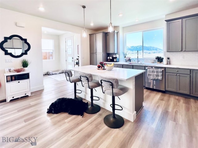 1823 N Cottonwood Rd, Bozeman, MT 59718 - kitchen featuring dishwasher, gray cabinets, a sink, a kitchen bar, and recessed lighting