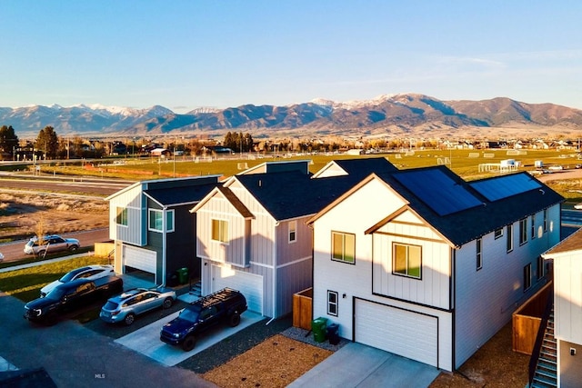 1823 N Cottonwood Rd, Bozeman, MT 59718 - view of front facade with an attached garage, a mountain view, and concrete driveway