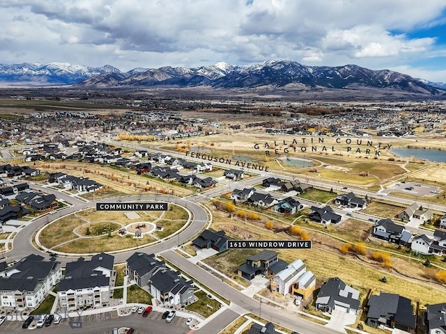 birds eye view of property featuring a water and mountain view and a residential view