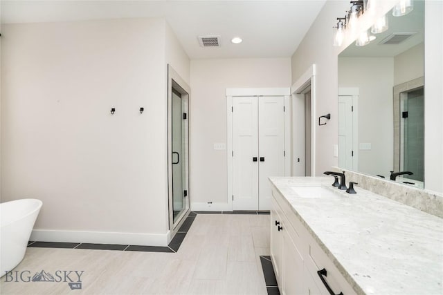 full bath featuring visible vents, baseboards, a shower stall, and vanity