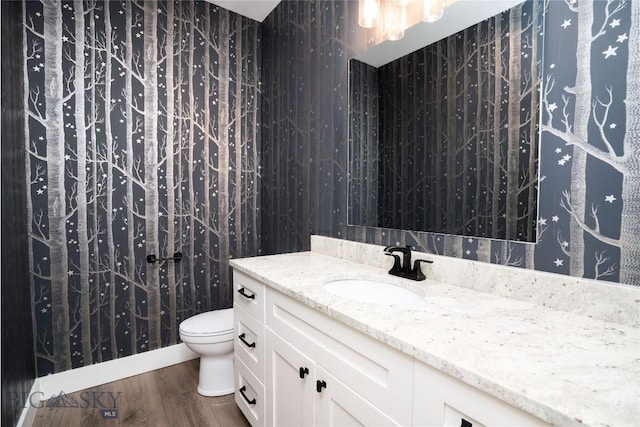 1610 Windrow Dr, Bozeman, MT 59718 - bathroom featuring vanity, toilet, and wood finished floors