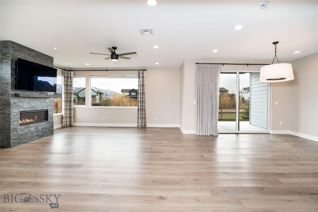 1610 Windrow Dr, Bozeman, MT 59718 - unfurnished living room with a fireplace, plenty of natural light, ceiling fan, light wood-type flooring, and recessed lighting