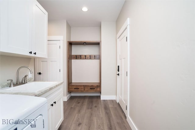 1610 Windrow Dr, Bozeman, MT 59718 - laundry area featuring cabinet space, washer / dryer, light wood finished floors, baseboards, and recessed lighting