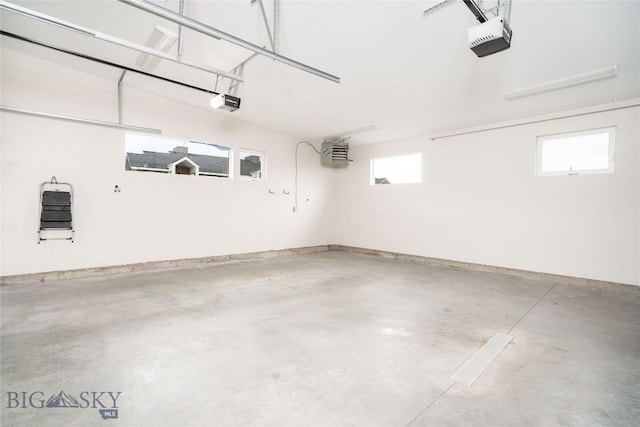 garage with baseboards and a garage door opener