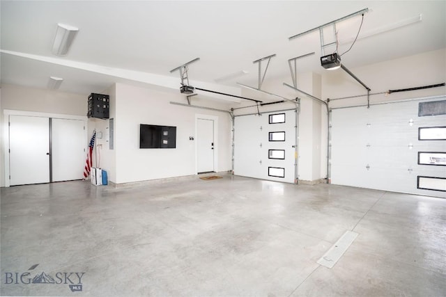 garage featuring a garage door opener and electric panel