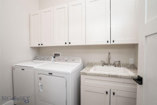 laundry area with a sink, independent washer and dryer, and cabinet space