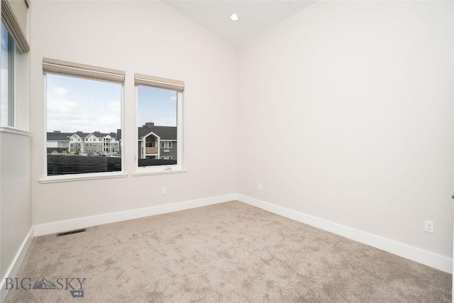 carpeted spare room with baseboards and recessed lighting