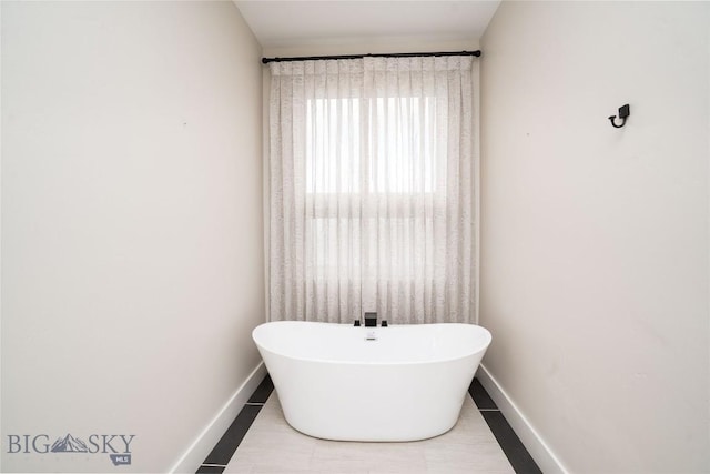 1610 Windrow Dr, Bozeman, MT 59718 - bathroom featuring a freestanding bath and baseboards