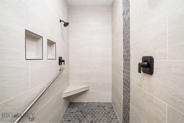 bathroom with a tile shower